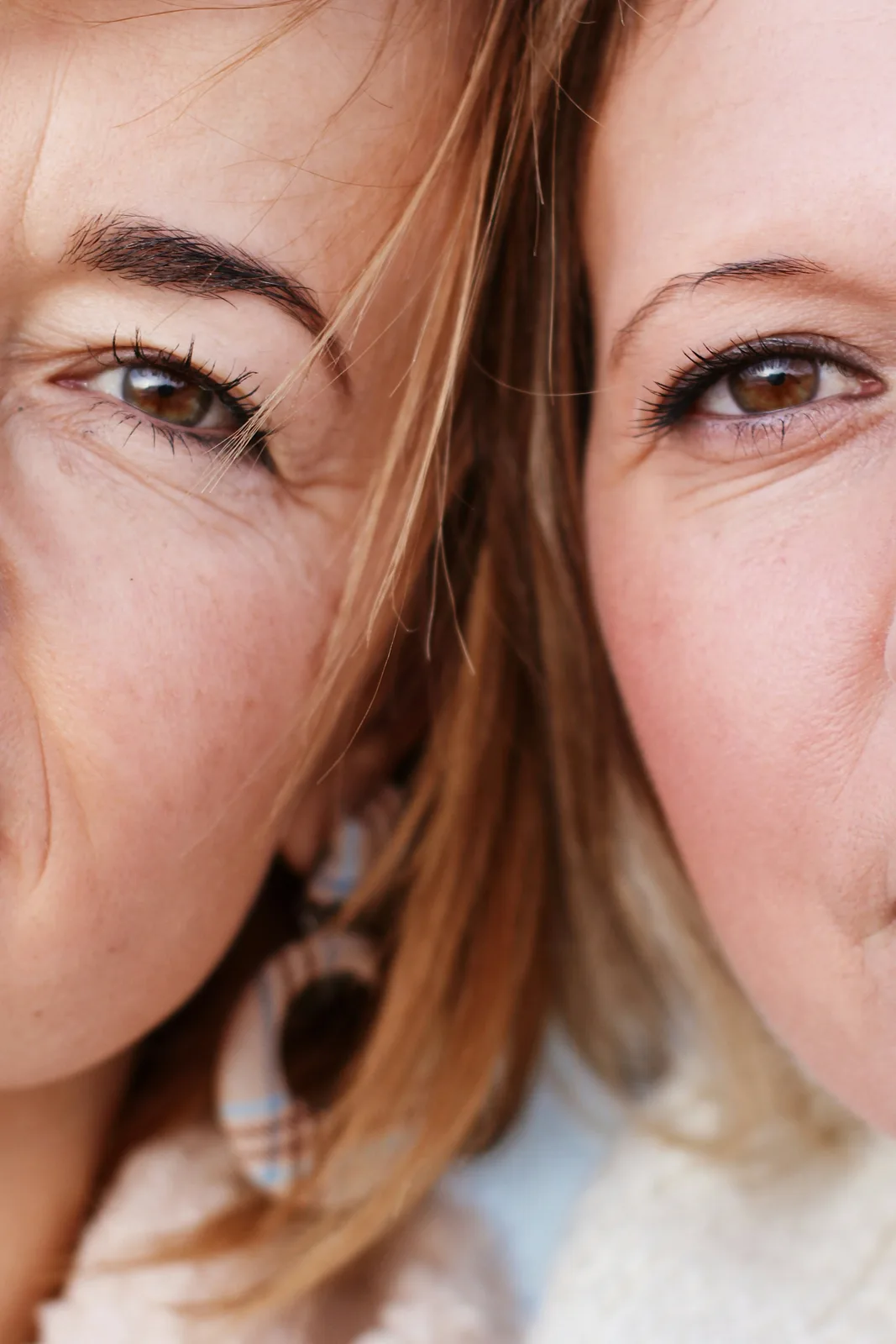 Two women cheek to cheek, looking at the camera
